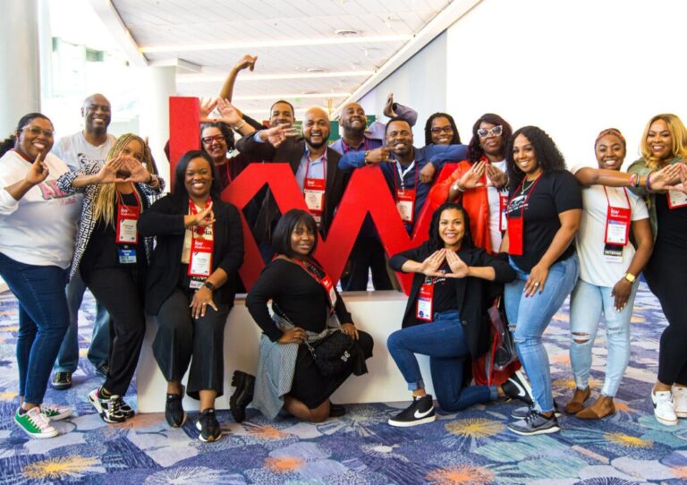 Agentes Keller Williams alrededor del isotipo KW de la marca